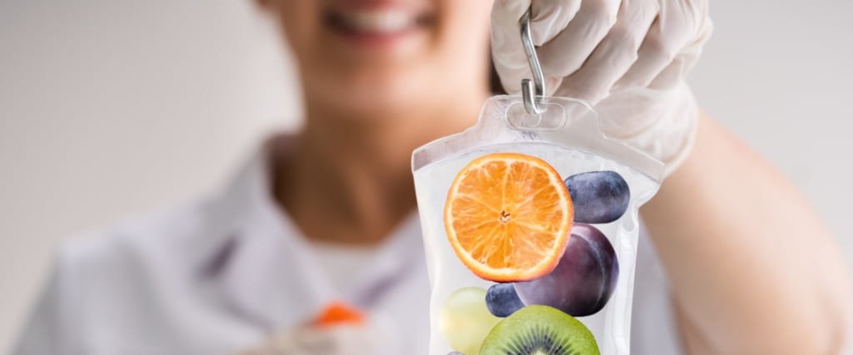 Doctor holding up a saline bag for IV therapy