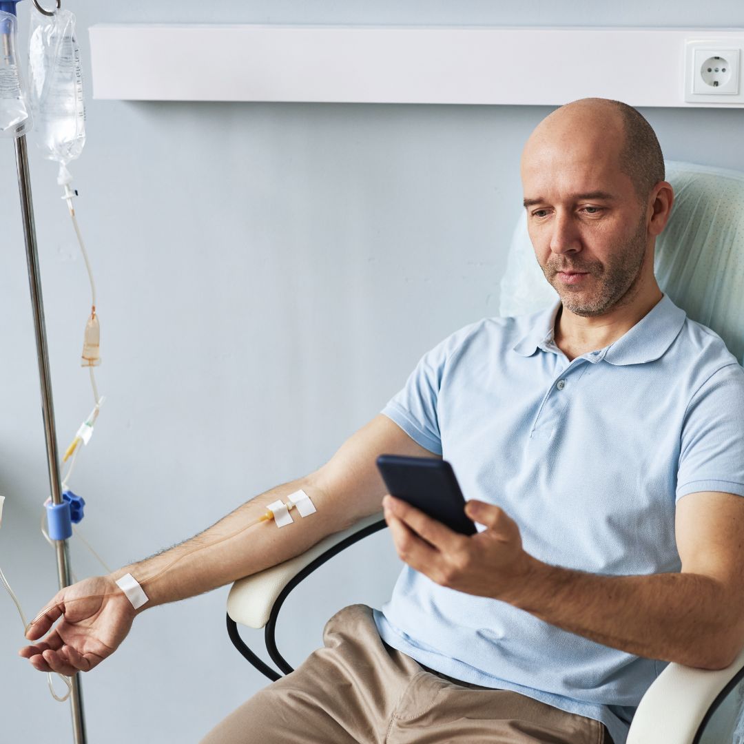 a man taking IV Hydration therapy to boost wellness and hydration.