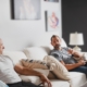 Two men on a couch receiving IV therapy with a visible drip, promoting vitamins for testosterone support.