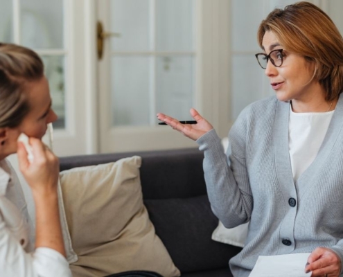 A medical professional and a client discussing the benefits of Intravenous Glutathione in a modern wellness clinic.