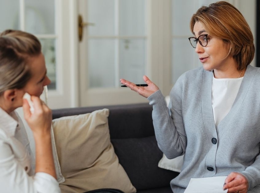 A medical professional and a client discussing the benefits of Intravenous Glutathione in a modern wellness clinic.
