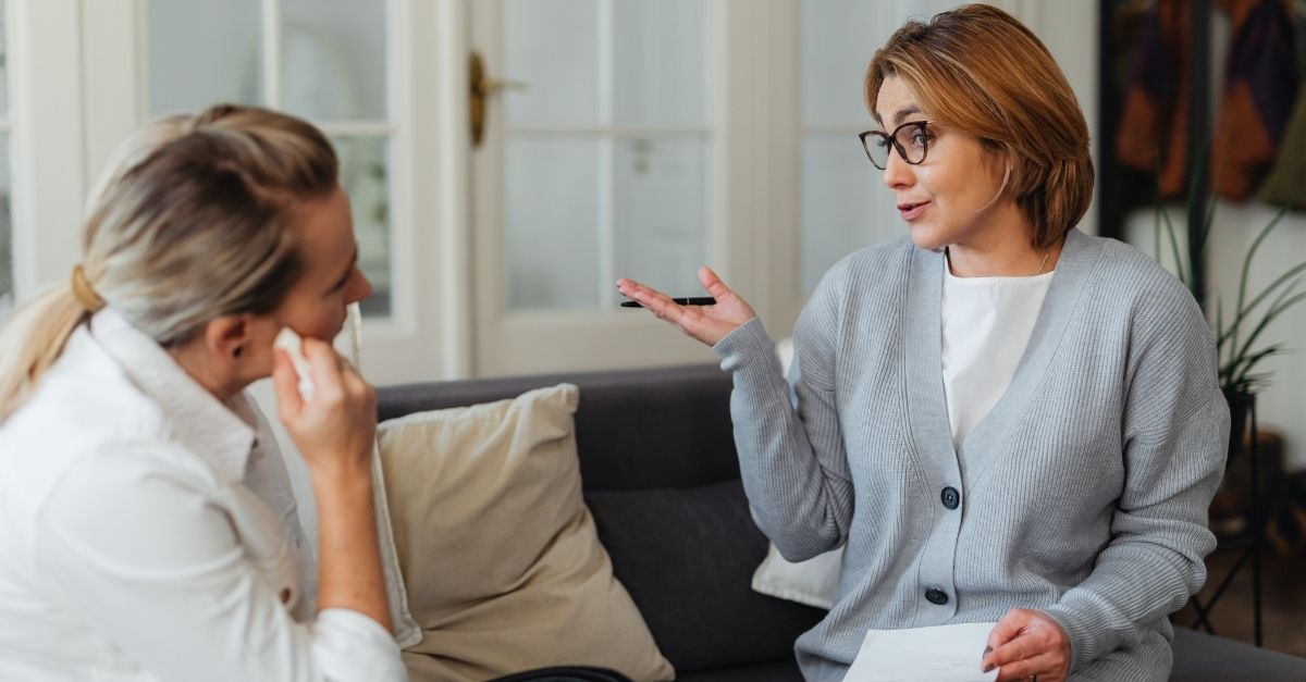 A medical professional and a client discussing the benefits of Intravenous Glutathione in a modern wellness clinic.