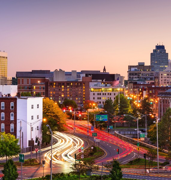 A vibrant city skyline at dusk, representing the Worcester service areas.